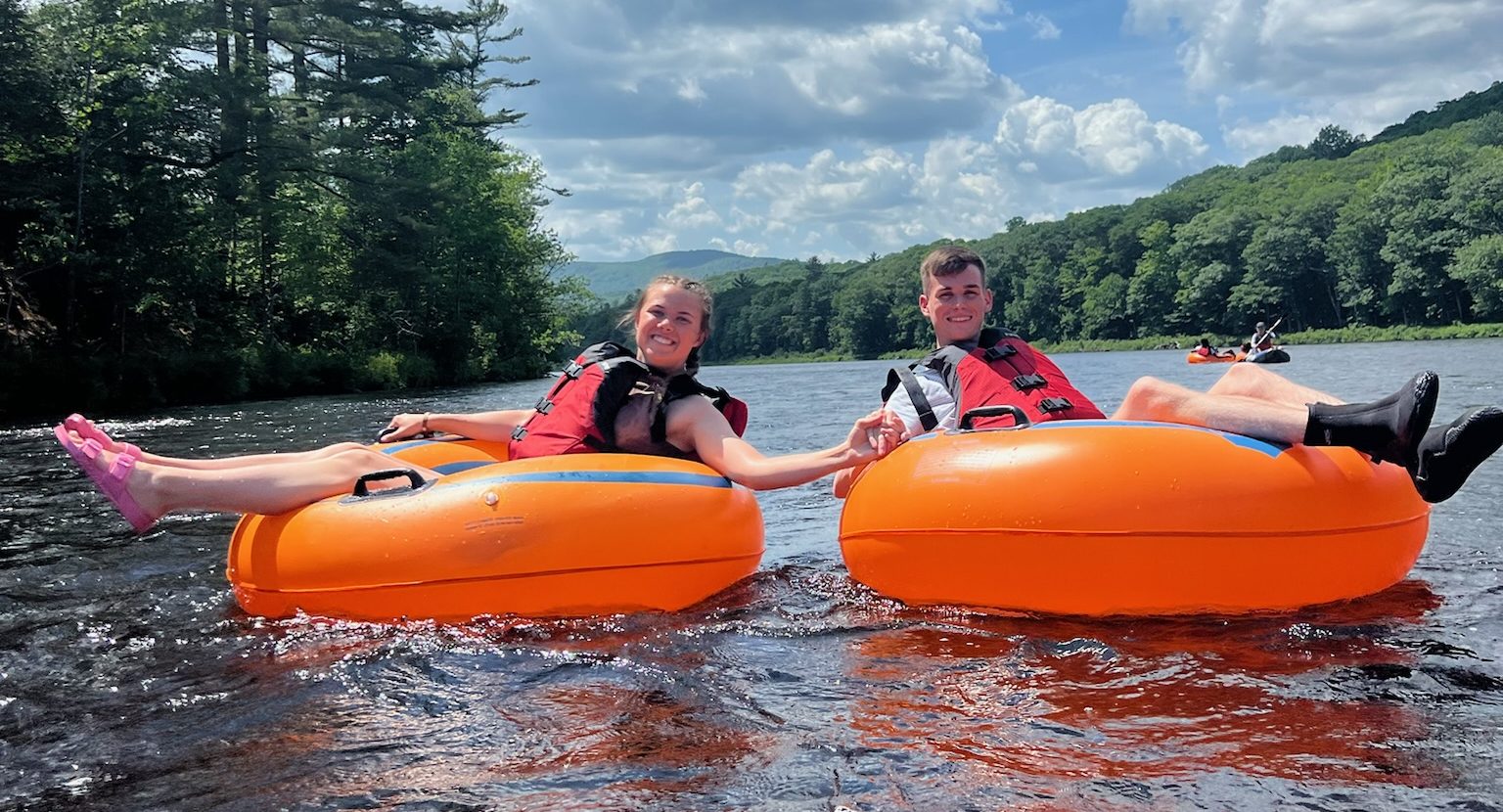 A couple floating in orange tubes